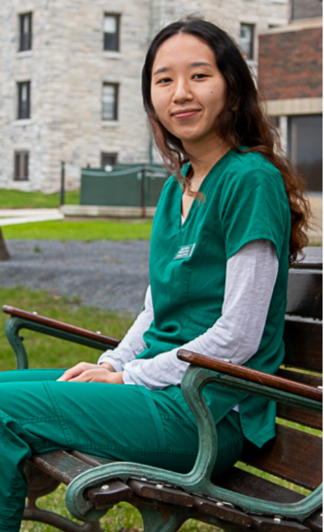 Jaza Amchok on a bench outside UVM LCOM